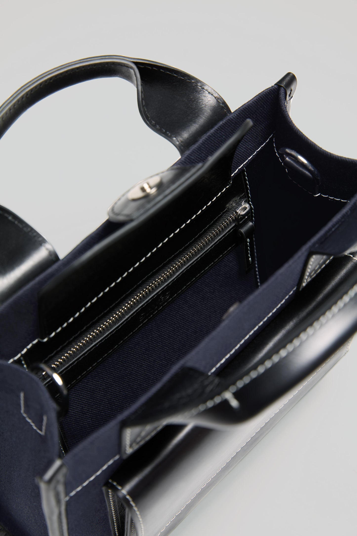 STITCHED POCKET MINI TOTE IN NAVY/BLACK